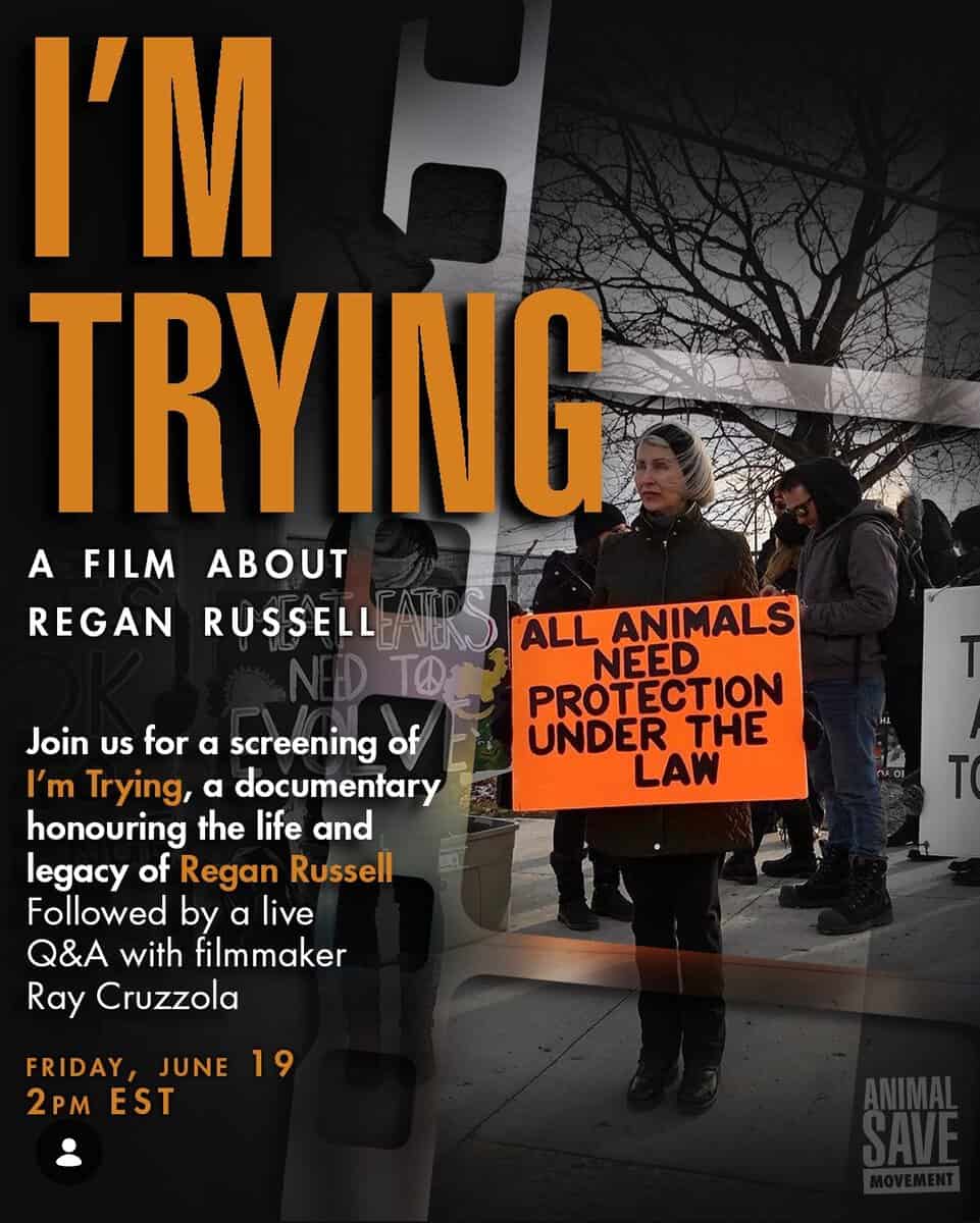 Protesters holding a sign that reads 'All animals need protection under the law' during a screening event for the documentary 'I'm Trying' about Regan Russell.